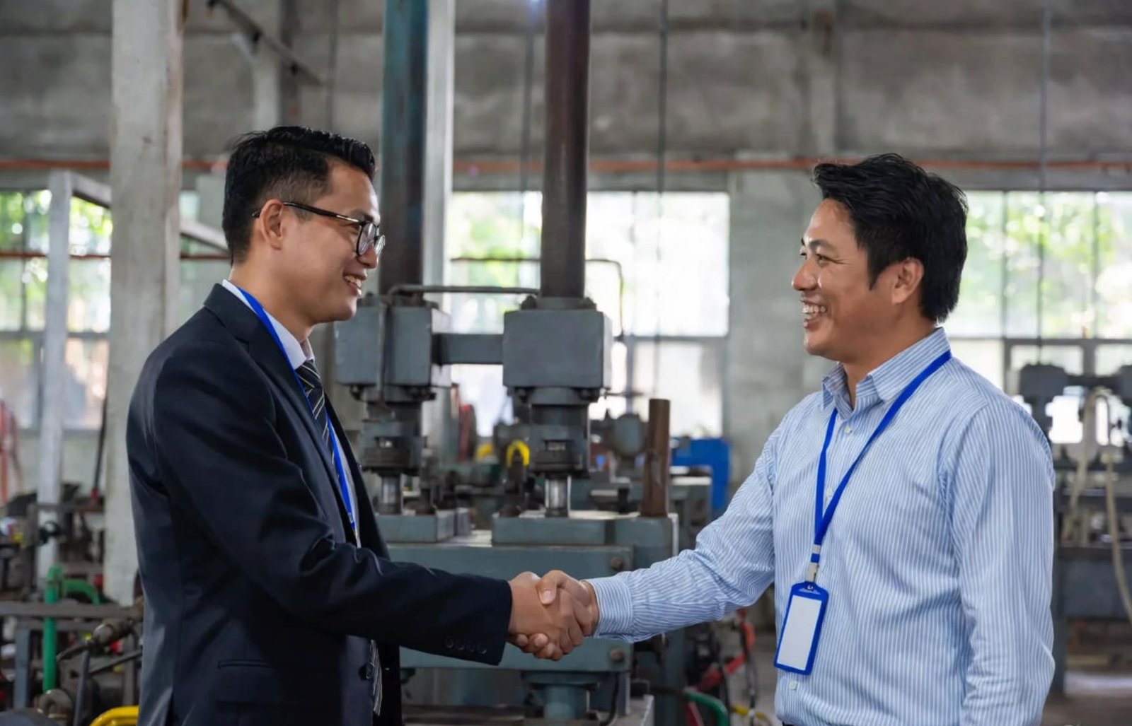 A handshake sealing a deal between a factory and a material supplier